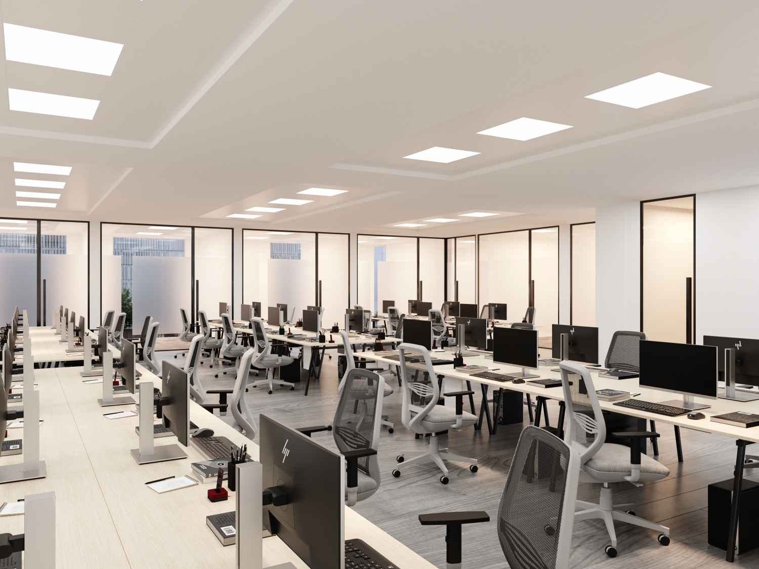 Modern office workspace featuring sleek desks, ergonomic chairs, and multiple computer stations, showcasing the efficient design and layout emphasized in Hausfit's office renovation services.