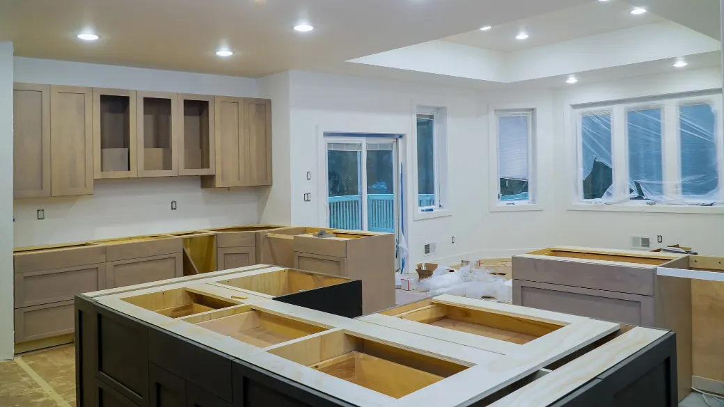 Modern kitchen renovation in progress, featuring unfinished cabinetry and a bright, open layout, emphasizing efficient design and transformation.