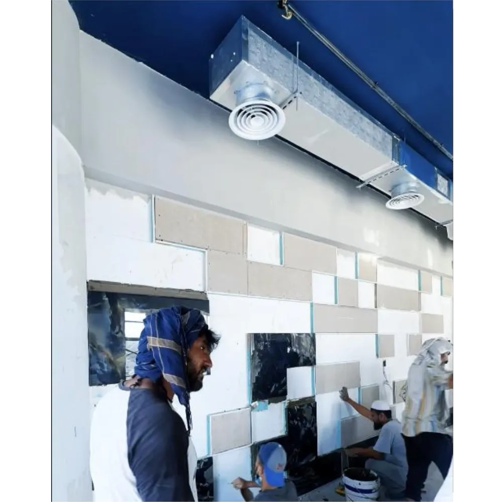 Workers installing premium tiles and cement board for an advanced wall design in an office renovation, showcasing modern materials and techniques.